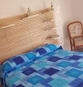 a bedroom with a bed with a wooden window at Sea House in Marzamemi