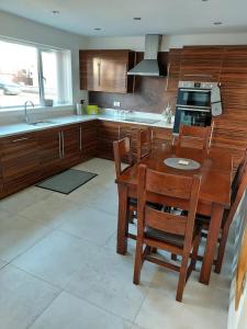 a kitchen with a wooden table and wooden cabinets at Detached 2 bedroomed bungalow Billingham Stockton on Tees in Stockton-on-Tees