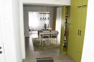 a kitchen and dining room with a table and a dining room at Apartment Sarajlic in Prijedor