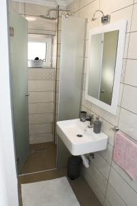 a bathroom with a sink and a mirror at Apartment Sarajlic in Prijedor