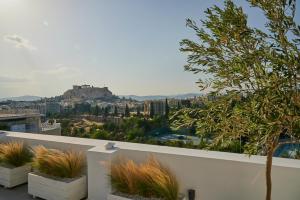 a view of the acropolis from a balcony with plants at Ma Maison Acropolis Mansion, Penthouse Suite No7 with exclusive roof garden, Ultra High Speed Internet 500 Mbps, 500 meters from Acropolis in Athens