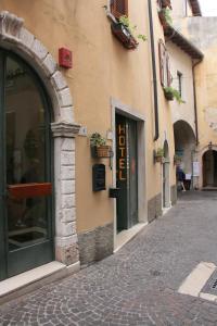 a cobblestone street in front of a building at Hotel Modena old town in Malcesine