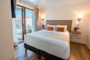 Postel nebo postele na pokoji v ubytování Tagle Hotel Boutique
