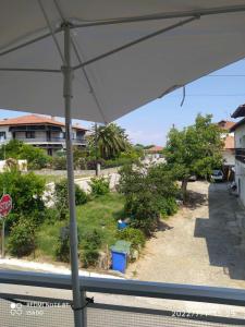 a view from a window of a street with a stop sign at Long Beach Apartment in Makrygialos