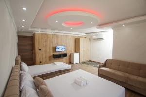 a large room with two beds and a couch at B H B Apartmani in Novi Pazar