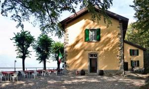 un bâtiment avec des tables et des chaises devant lui dans l'établissement Ristorante Hotel Falchetto, à Brunate