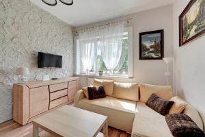 Televízia a/alebo spoločenská miestnosť v ubytovaní Oliwa House by Platinium Lofts