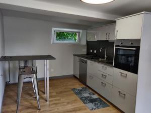 a kitchen with a counter and a table in it at Aux belles pierres in Carcagny