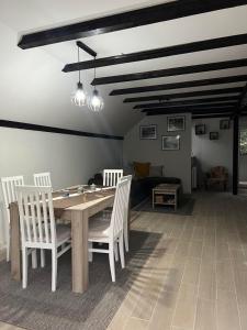 a dining room with a wooden table and chairs at Zavojsko jezero - Vila Jezero in Pirot