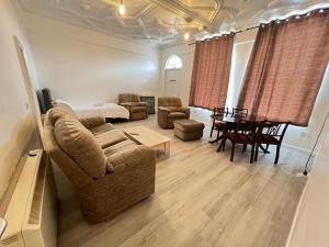 a living room with a couch and a table at Spacious Entire Flat, 1 in Great Yarmouth +3 photos