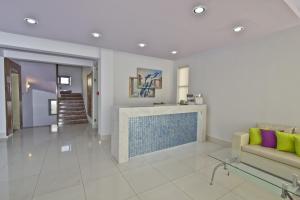a living room with a fireplace and a couch at Nafsika Hotel in Rhodes Town