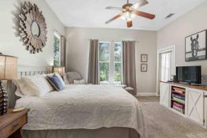 a bedroom with a bed and a ceiling fan at Southern Oaks Guest House in Abita Springs