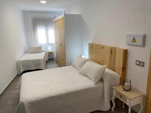 Łóżko lub łóżka w pokoju w obiekcie Alojamientos Tía María