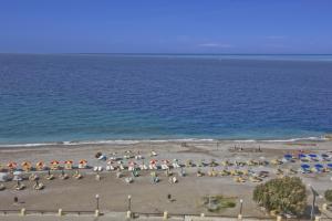 a group of umbrellas and chairs on a beach at Nafsika Hotel in Rhodes Town