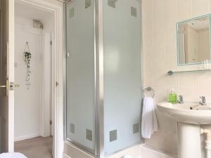 a bathroom with a shower and a sink at Penderels, Willersey in Broadway