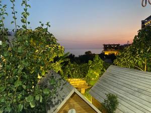 a view of the ocean from a roof of a house at Camping Albania-Secret Village Den in Sarandë