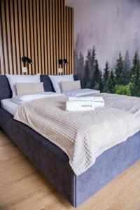 a bedroom with a large bed with a picture of trees at Forest 47 by Housine in Zator