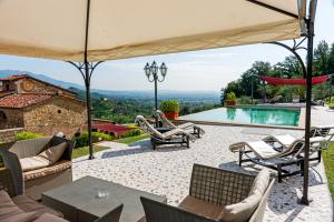 a villa with a swimming pool and a patio at Hotel Villa Volpi in Lucca