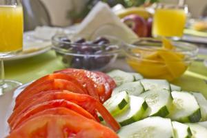 a plate of food with tomatoes and vegetables on a table at Nafsika Hotel in Rhodes Town