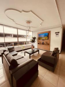 a living room with a couch and a table at Hotel Suite Center Pereira in Pereira