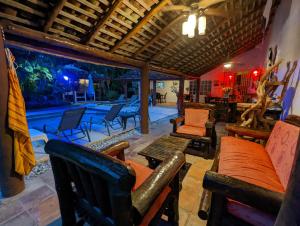 a living room with chairs and tables and a pool at Villa Botero By Casa Mojito in Santa Clara