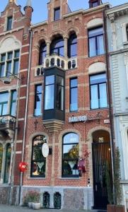 a brick building on a city street at BareFoodGIULIA in Hasselt