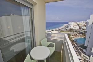 a balcony with a table and a view of the ocean at Nafsika Hotel in Rhodes Town
