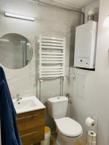 a bathroom with a toilet and a sink and a mirror at Apartament Morski in Jarosławiec