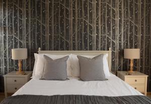 a bedroom with a white bed with two nightstands and two lamps at Furlong Cottage @ Higher Stancombe Farm in Kingsbridge