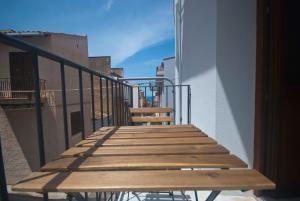 a wooden stairway leading up to a balcony at GIADA in Castellammare del Golfo