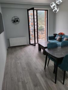 a living room with a couch and a table at New stylish 2 bedroom - Apartment in New building in Tbilisi City