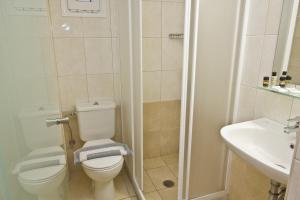 a bathroom with a toilet and a sink at Nafsika Hotel in Rhodes Town