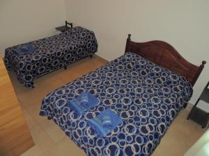 מיטה או מיטות בחדר ב-Departamento Temporario FIDO ZAFIR