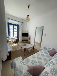 a bedroom with two beds and a table and a dining room at Veneto's Garden in Kardamyli