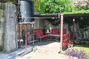 a patio with a table and chairs and a barrel at Sofia Rooms in Tivat