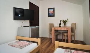 a small room with a small table and a television at Sofia Rooms in Tivat