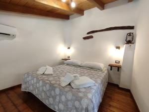 een slaapkamer met een bed met handdoeken erop bij La Corte Dei Baroni in Loceri