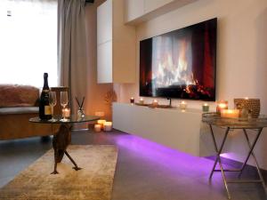 a dog standing in a living room with a fireplace at SuiteDreams - Relax Suite Liège in Liège