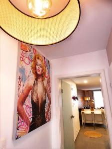 a ceiling with a painting of a woman on a wall at SuiteDreams - Relax Suite Liège in Liège