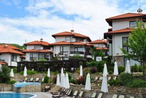 a resort with a pool and some chairs and umbrellas at Villa Ivana - Bay View Villas in Kosharitsa