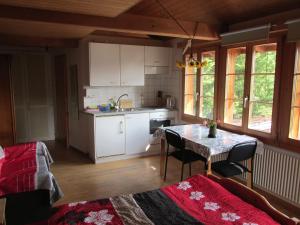 a small kitchen with a table and a table and chairs at BnB Erlach in Erlach