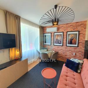 a living room with a couch and a brick wall at Crown Imperial Fort Grand Resort in Elenite