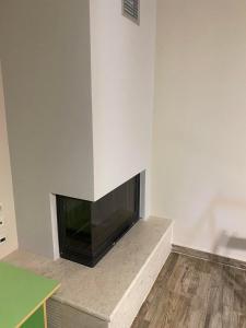 a living room with a flat screen tv on a wall at KRATHIS APARTMENTS ΜΕΓΑΛΟ in Paralía Platánou