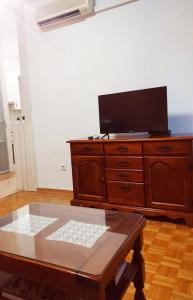 a living room with a tv on top of a dresser at Apartment Karla in Split