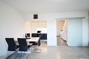 a dining room and kitchen with a table and chairs at Apartman Lukas in Rabac +24 photos
