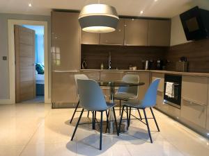 a kitchen with a table and chairs in it at Quarry House in Stamford