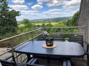 a blue table on a balcony with a view at Enjoy Durbuy 5 in Durbuy