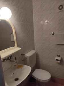 a bathroom with a toilet and a sink and a mirror at Apartmani More in Petrovac na Moru +59 photos