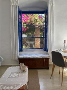 a room with a window with a bench and a table at Veneto's Garden in Kardamyli