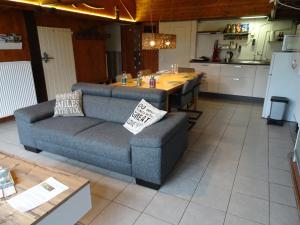 a living room with a couch and a table at B&B Verwoldsehof 'Op de deel' in Laren